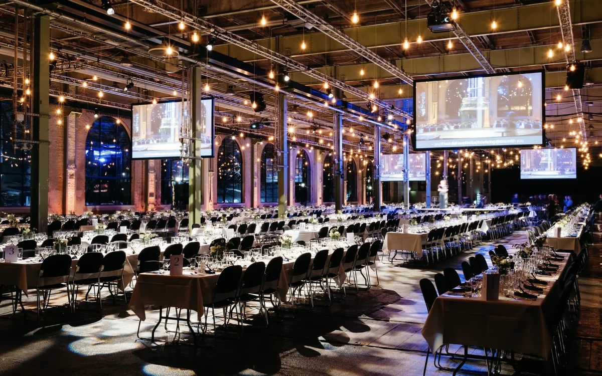 A banquet for hundreds under the steel trusses and string lights